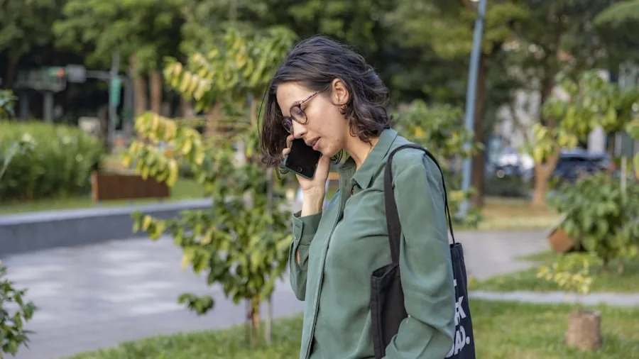 Person on phone call in natural outdoor setting, demonstrating clear communication