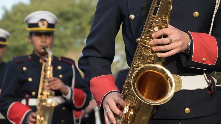 Person opening a saxophone case with instrument and accessories inside