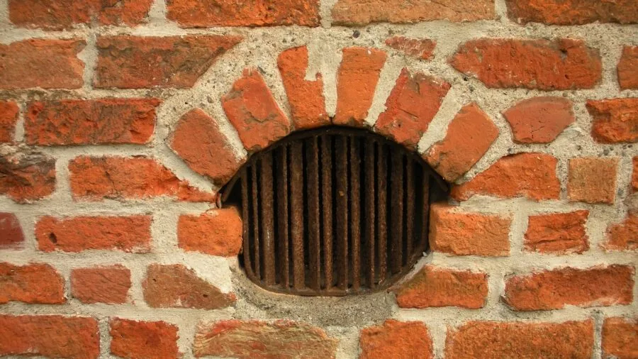 Person opening window in basement gym space for fresh air and ventilation