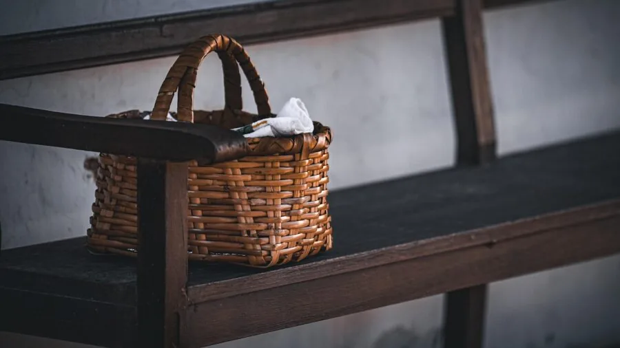 Person organizing and folding a portable storage basket for compact storage and transportation