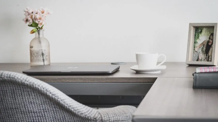 Person organizing and scanning important documents at a home office desk with natural lighting