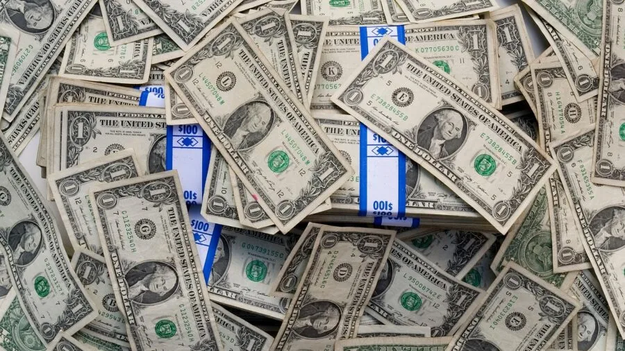 Person organizing cash and cards in wallet, representing financial planning and value consideration for purchases