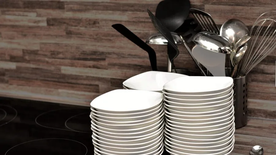 Person organizing clean dishes and plates in a kitchen cabinet, demonstrating practical dishware storage and arrangement