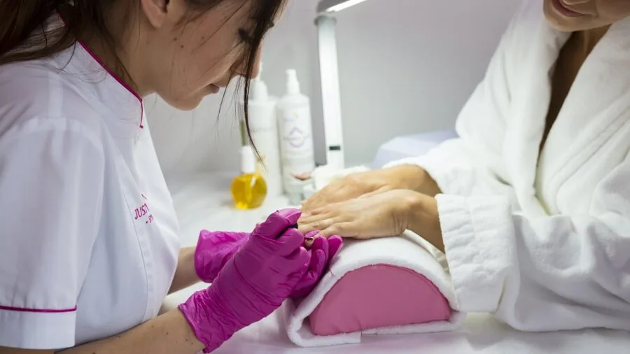 Person organizing nail care tools and files for home manicure preparation