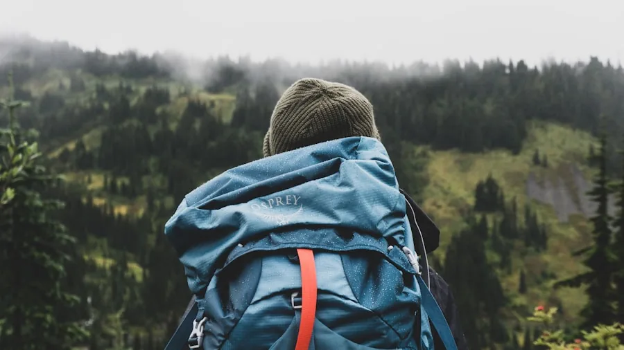 Person organizing portable items and gear into a backpack for travel, showing packing and portability concepts