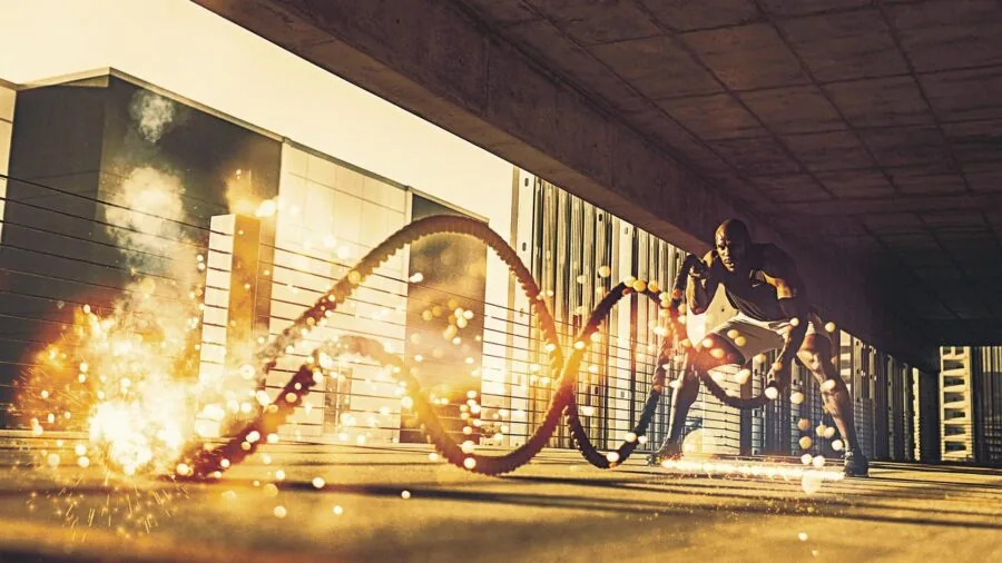Person performing dynamic rope training exercise outdoors in fitness workout session