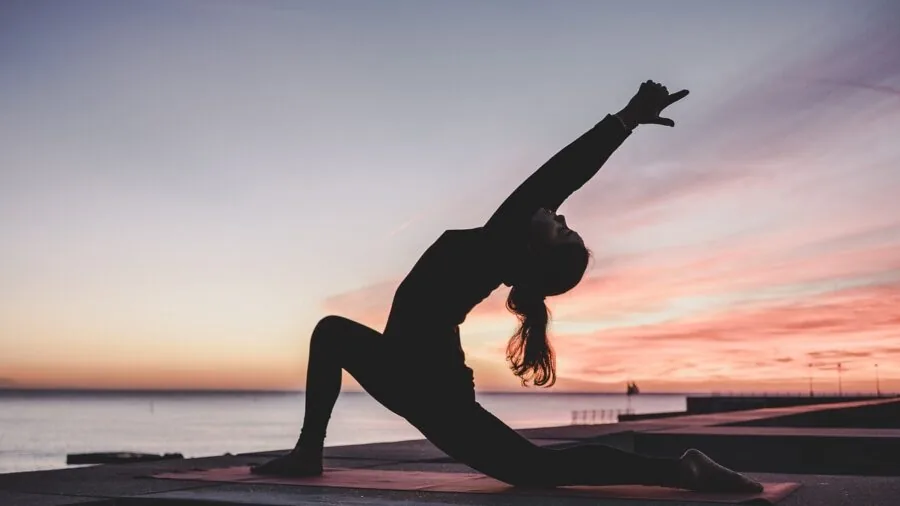 Person performing hamstring stretch during home workout session