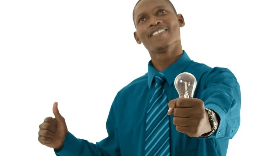 Person performing simple automotive maintenance on vehicle exterior lighting