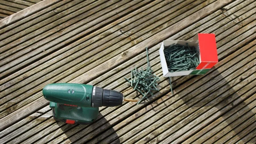 Person plugging in cordless vacuum charger at home charging station
