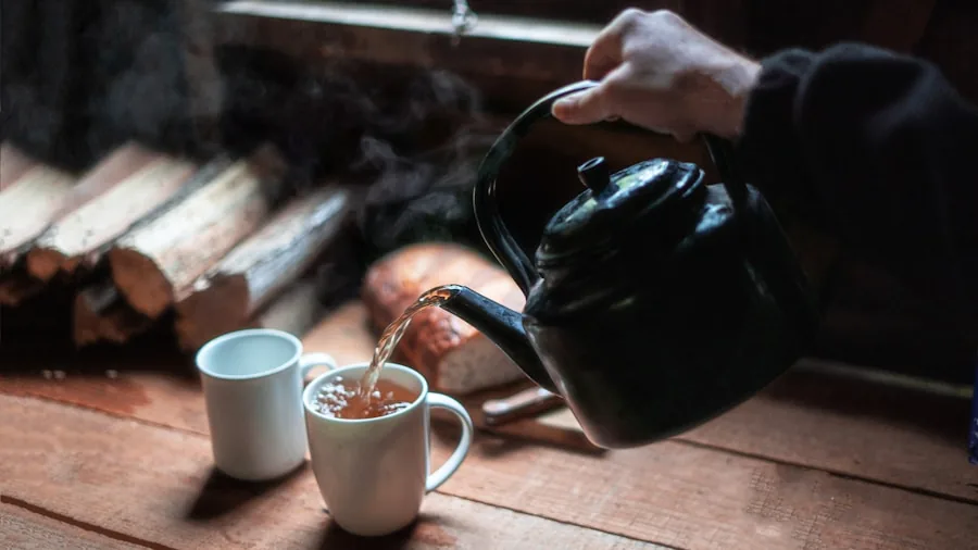 Person pouring hot water from gooseneck kettle into cup during morning routine