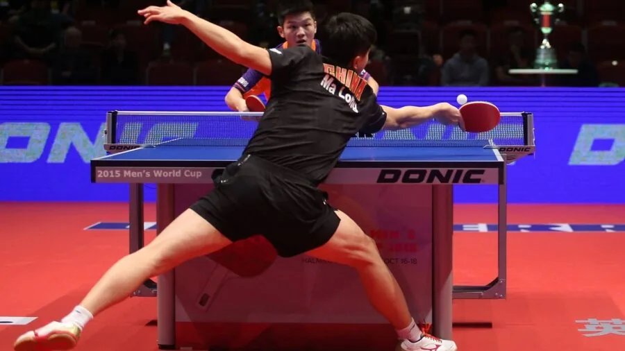 Person practicing basic table tennis strokes indoors, focused on proper form and technique