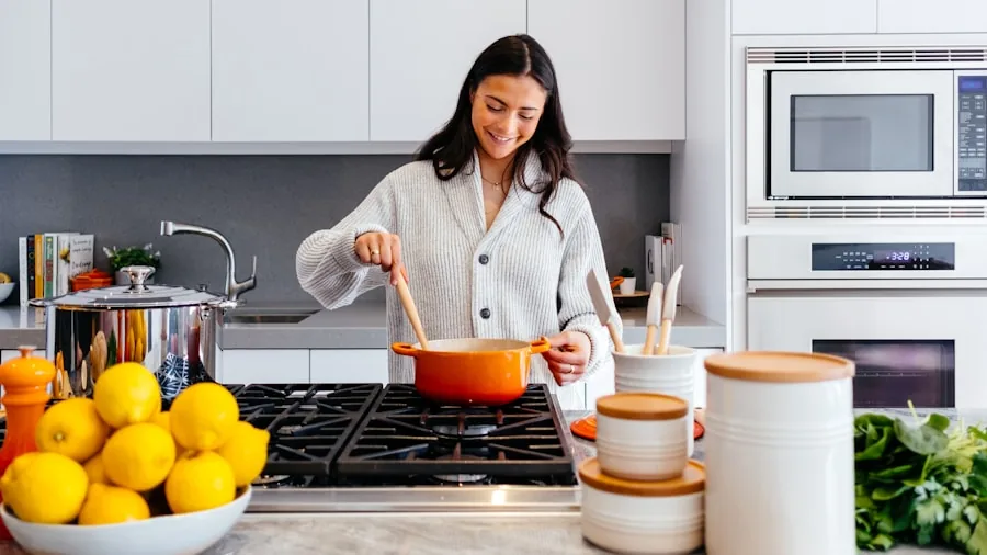 Person preparing diverse meals in modern kitchen with various cooking ingredients and cookware on counter