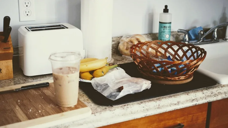 Person preparing tea in a small modern kitchen with minimal counter space