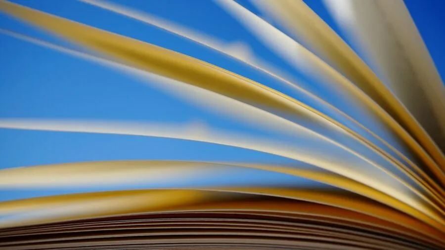 Person reading a book with focused clarity, demonstrating clear vision and optical quality