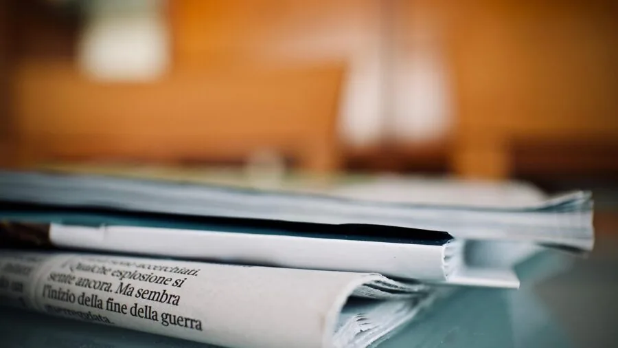 Person reading health supplement information and nutritional label details indoors