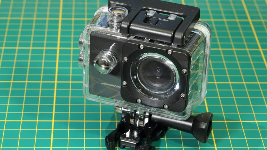 Person recording outdoor adventure with action camera mounted on helmet during mountain biking