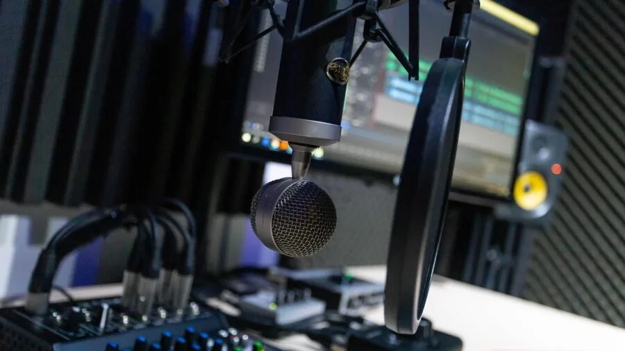 Person recording podcast in professional home studio with acoustic treatment on walls