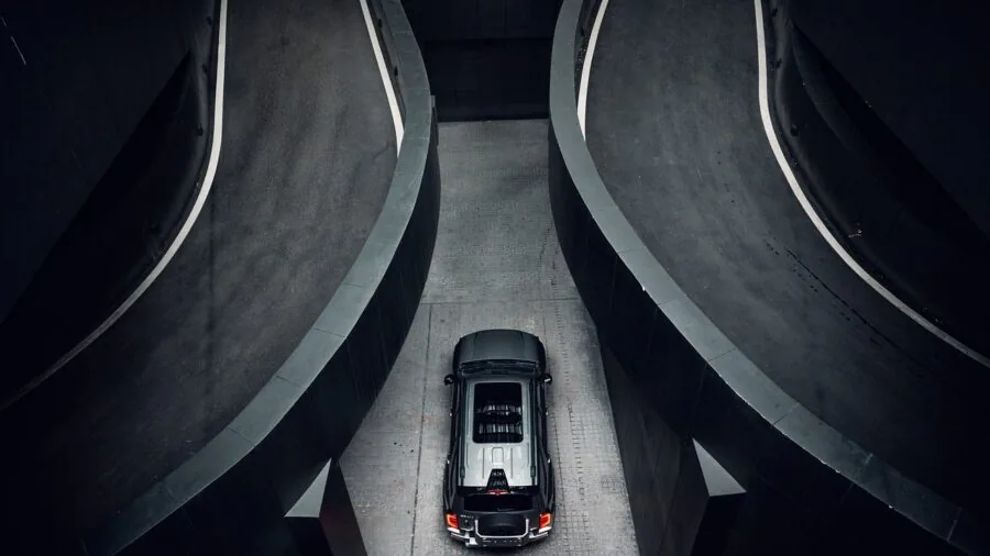 Person refilling water container in bright kitchen during morning wellness routine