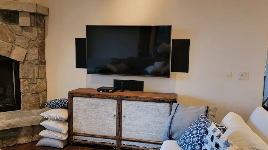 Person relaxing at home enjoying immersive audio from quality speakers while watching entertainment