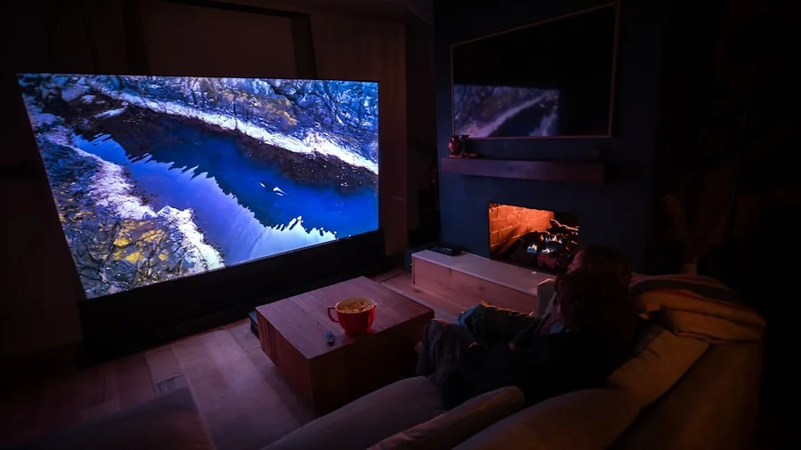 Person relaxing on couch while watching movie with surround sound audio setup in living room