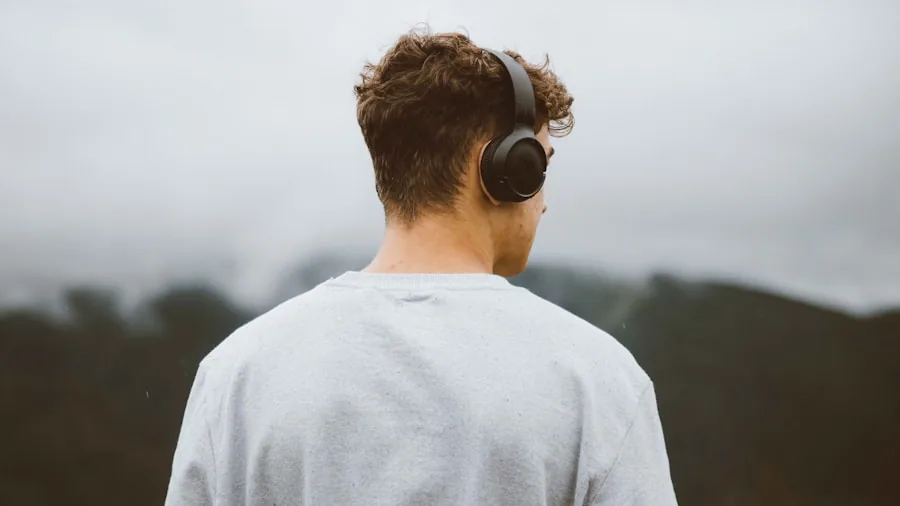 Person relaxing while listening to music with headphones, focused on comfort and audio quality
