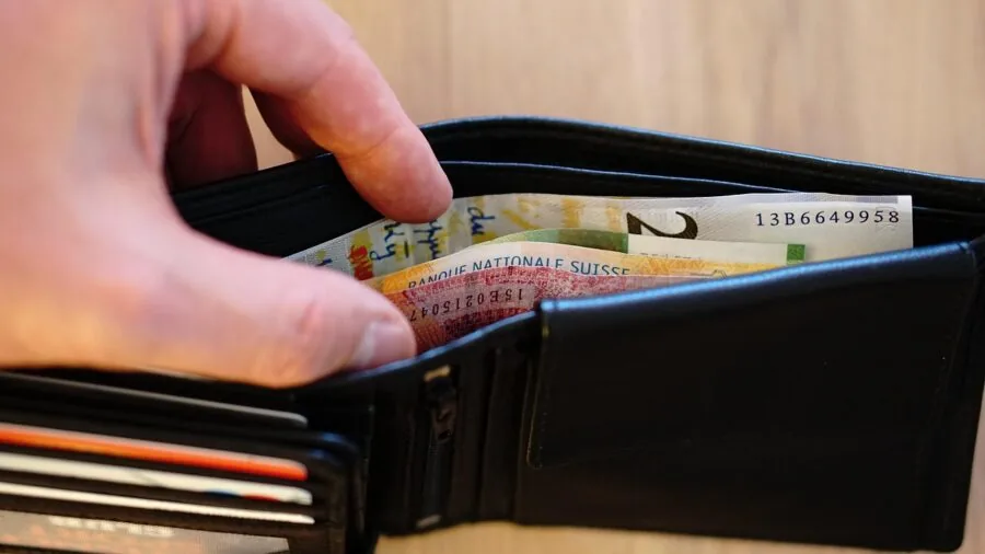 Person repeatedly opening and closing leather wallet to demonstrate durability and wear testing