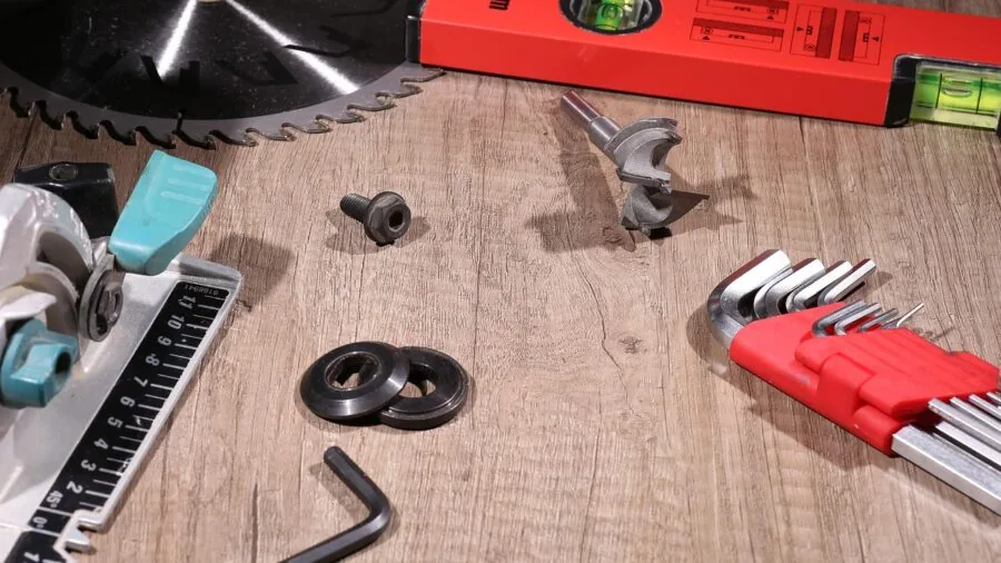 Person replacing a reciprocating saw blade during a woodworking project in a workshop