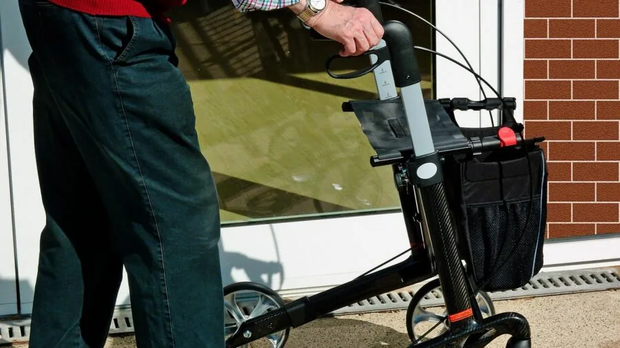 Person replacing batteries in a home security device during routine maintenance