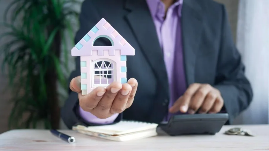 Person reviewing budget and financial documents at desk with coffee, planning expenses