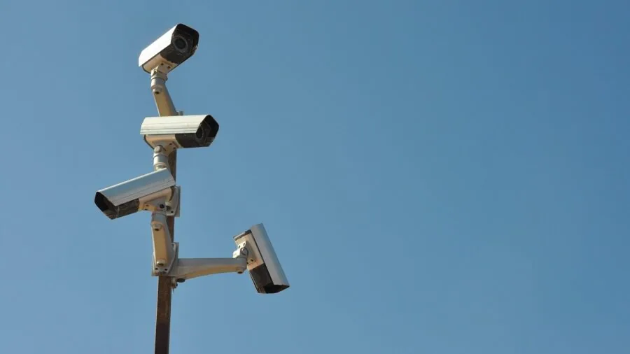 Person reviewing security system notification on smartphone at home during evening