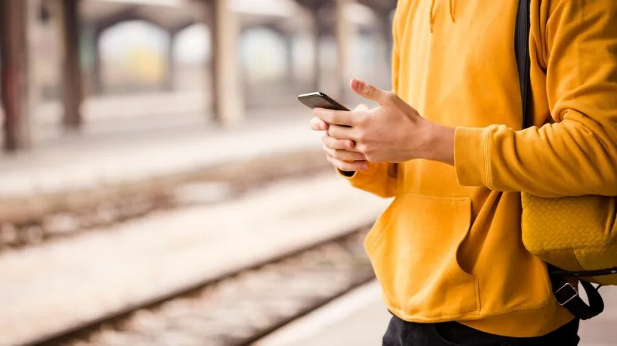 Person reviewing smartphone settings and compatibility requirements on mobile device screen