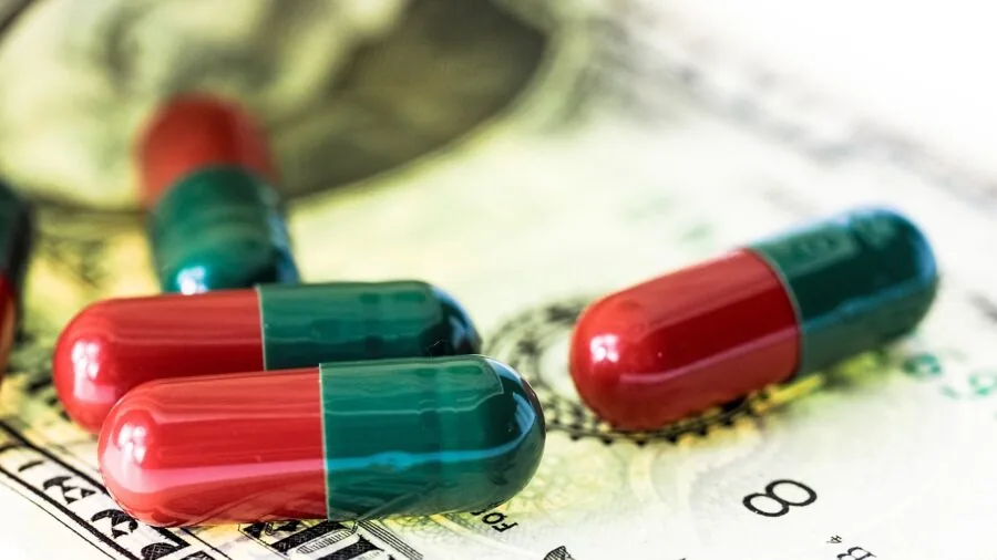 Person reviewing supplement costs and comparing prices while planning their fitness routine