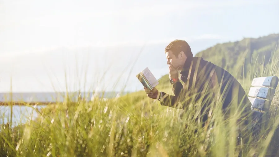 Person reviewing technical documentation while standing outdoors in natural wind conditions