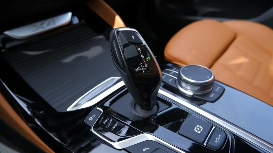 Person reviewing vehicle documentation to verify car model compatibility and specifications