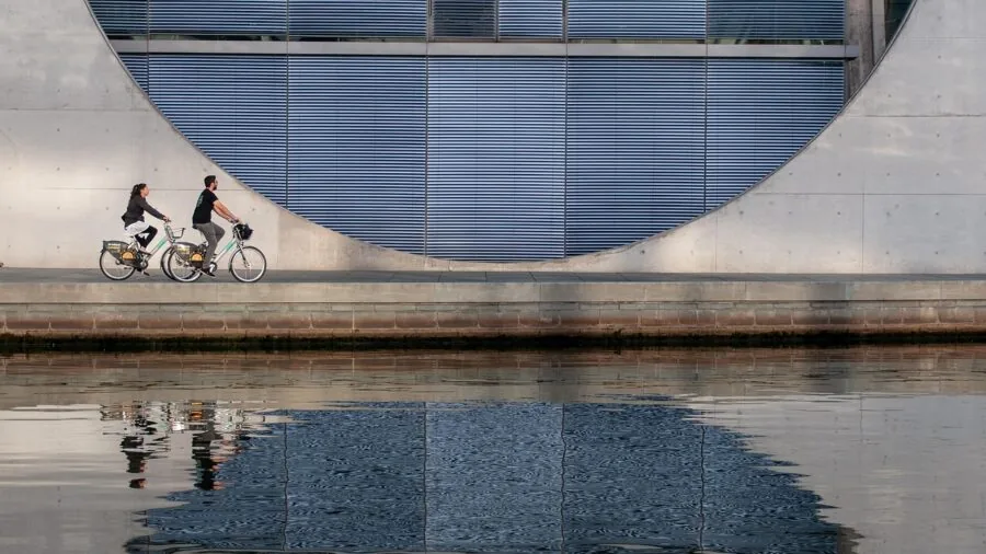 Person riding bike on flat city street during daytime commute