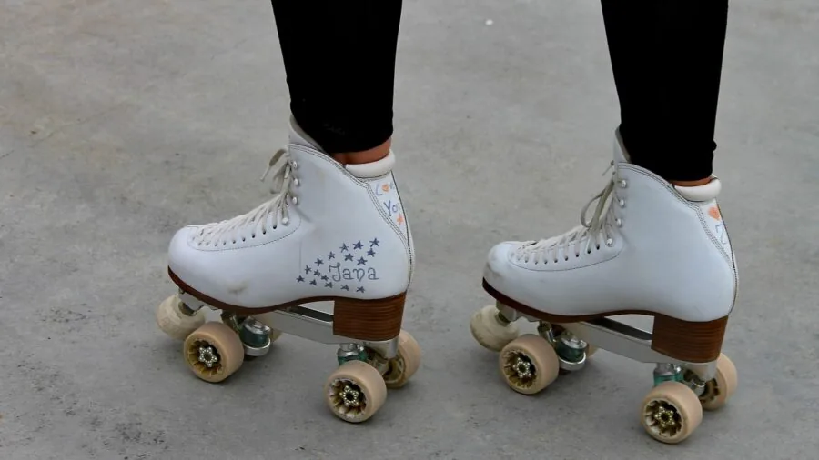 Person roller skating on outdoor pathway, showing real-world skating usage and environment