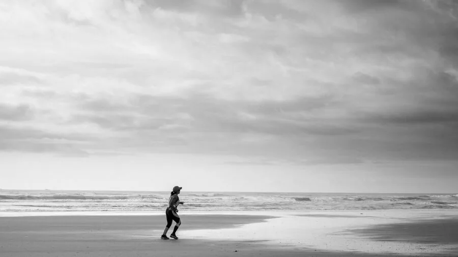 Person running outdoors demonstrating proper form and body stability during exercise