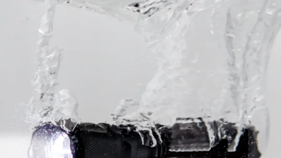 Person sealing a waterproof pouch before water activities, demonstrating closure mechanism reliability
