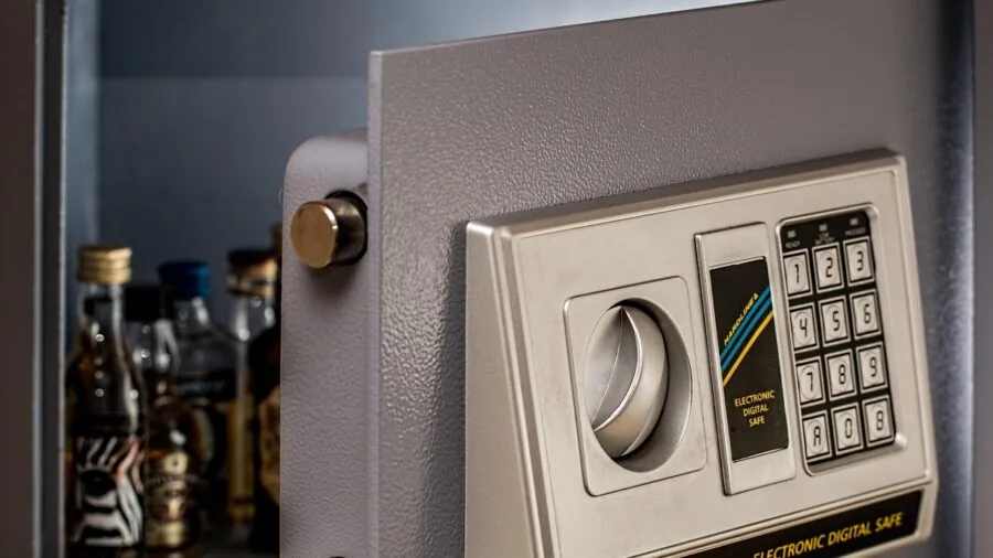 Person securing important documents and valuables in a locked safe for protection and peace of mind
