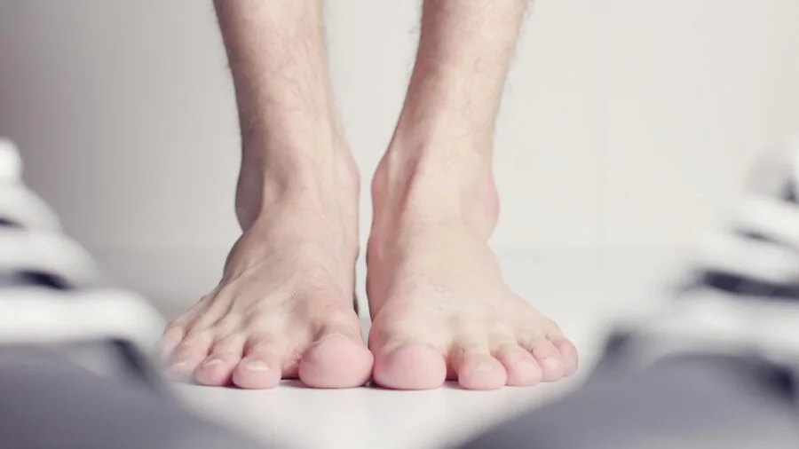 Person sitting down trying on shoes without socks to check fit and comfort