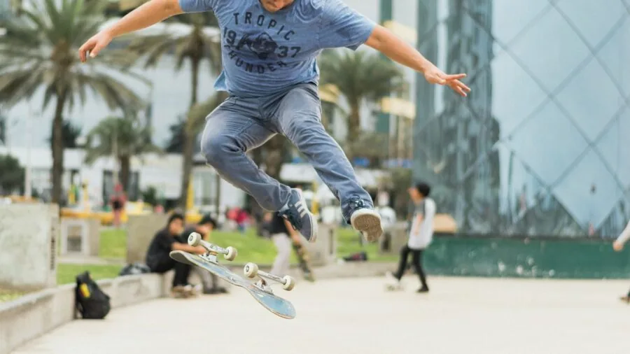 Person skateboarding on smooth concrete surface, demonstrating smooth wheel rolling and riding technique