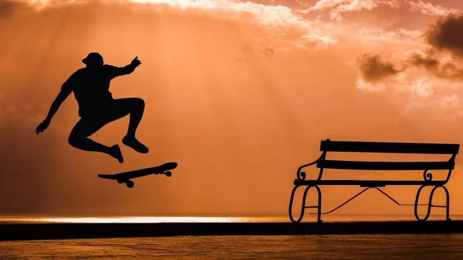 Person skateboarding on urban pavement, demonstrating turning and board control