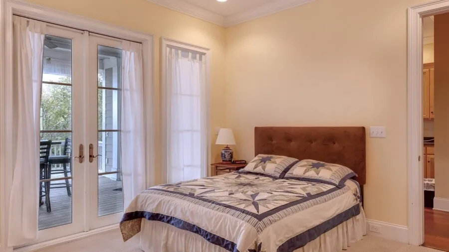 Person sleeping comfortably in bed with natural light streaming through window