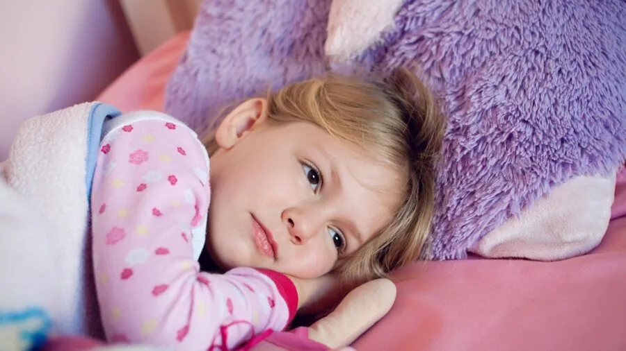 Person sleeping comfortably on bed with pillow supporting their body in relaxed position