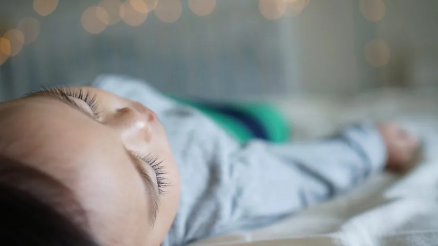 Person sleeping peacefully on bed with stable mattress support throughout the night