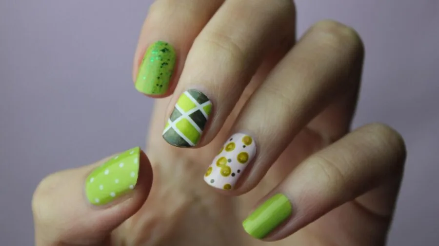 Person soaking nails in acetone solution for gel polish removal at home