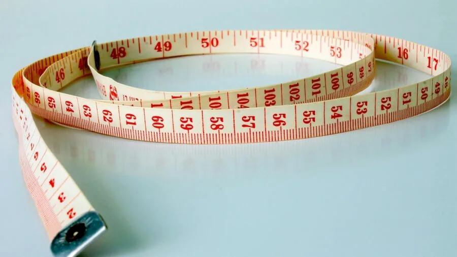 Person standing on a bathroom scale for body composition measurement and health monitoring