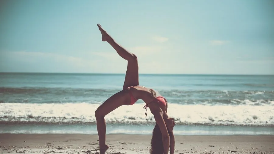 Person stretching arm during outdoor fitness routine, demonstrating athletic wear for exercise recovery