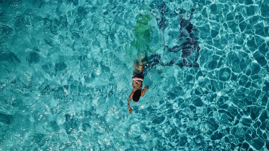 Person swimming in water during outdoor summer activity, demonstrating water-resistant sunscreen durability