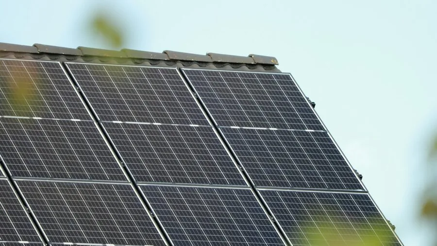 Person testing solar panel efficiency in natural sunlight outdoors